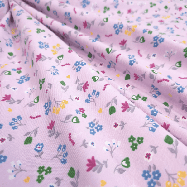 Baumwolljersey – MEHRFARBIGE BLUMEN MIT ROSA HINTERGRUND – Mindestzuschnitt oder Vielfaches von 25 x 140 cm